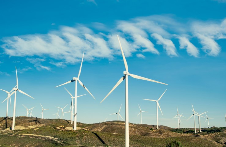 a wind turbine transfers energy from __________ energy store. what one word completes the sentence?